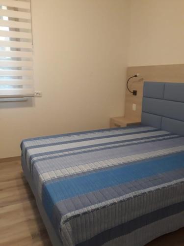 a bed in a room with a blue mattress at Il Sole e la Luna B&B in Garda in Garda