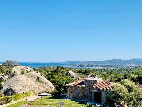 a stone house on top of a hill at Art Villa in San Teodoro