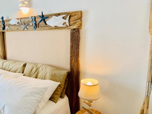 a bedroom with a bed with a wooden headboard at Art Villa in San Teodoro