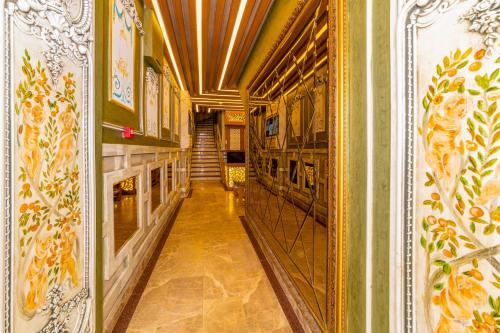 a hallway in a building with a mirror at Golden Sand Hotel in Istanbul