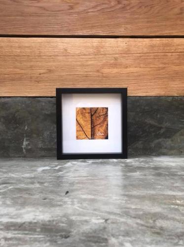 a picture of a tree in a picture frame on the floor at Las Casitas de Santillana in Santillana del Mar