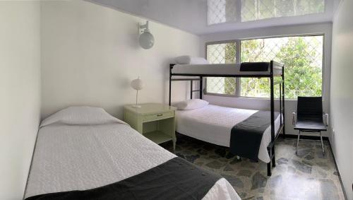 a bedroom with two bunk beds and a window at La Toscana in Chinauta