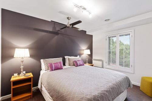 a bedroom with a bed and a ceiling fan at Frewville 7A Apartment in Mount Gambier