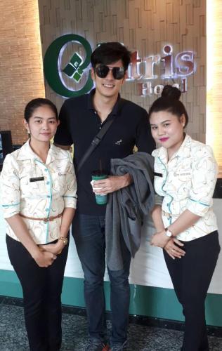 a man and two women standing in front of a store at The Centris Hotel Phatthalung in Phatthalung
