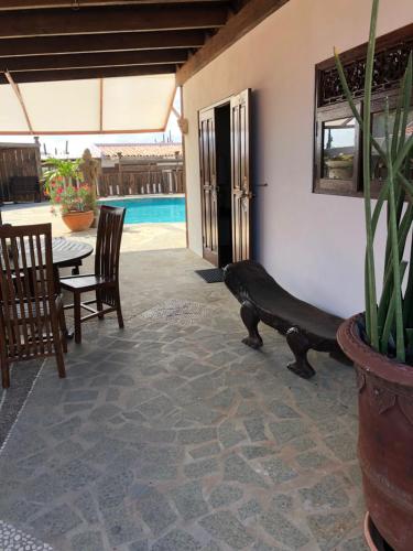 a patio with a table and chairs and a pool at Via Monica in Santa Cruz