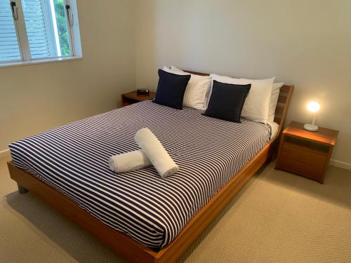 a bedroom with a bed with two towels on it at Aqua Promenade Beachfront Holiday Apartments in Sunrise Beach
