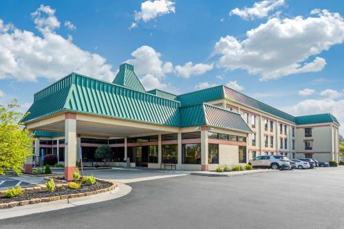 a large building with a green roof and a parking lot at Quality Inn & Suites Olde Town in Portsmouth