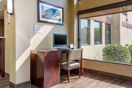 an office with a desk with a computer and a chair at Quality Inn & Suites Olde Town in Portsmouth