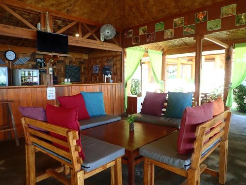 a room with a table and chairs and a couch at Two Fish Resort Lembeh in Bitung