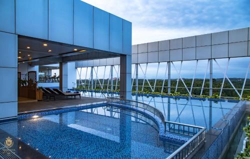 a view of a building with a swimming pool at KPM TRIPENTA HOTEL in Kozhikode