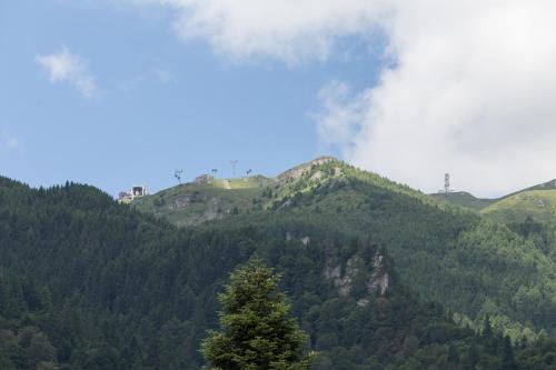 a mountain with smoke coming off the top of it at Pensiunea Carmen`s Mansion B in Sinaia