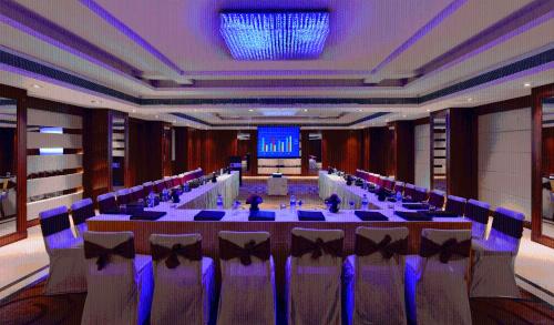 a conference room with a long table and chairs at Lords Plaza Jaipur in Jaipur