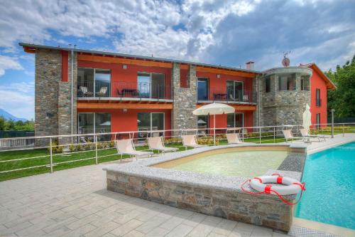a house with a swimming pool in front of a building at Residence Villa Paradiso in Gravedona
