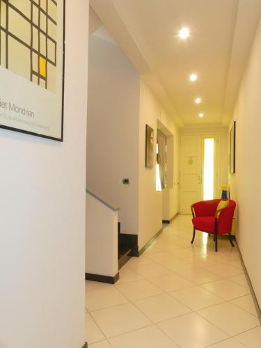 a hallway in a hospital with a red chair at Il Fiore di Monnalisa in Vinci