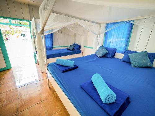 Postel nebo postele na pokoji v ubytování Scuba Republic Beach Bungalows