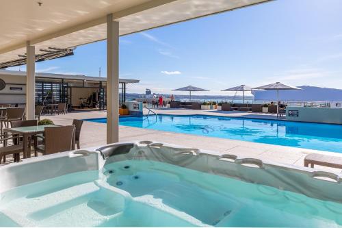 a hot tub on the roof of a hotel at Deluxe Heritage - Roof Top Pool & Gym near Sky Tower in Auckland