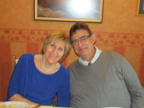 a man and a woman sitting at a table at chez Myla chambre avec tv écran plat et salle de bain privative in Bourges