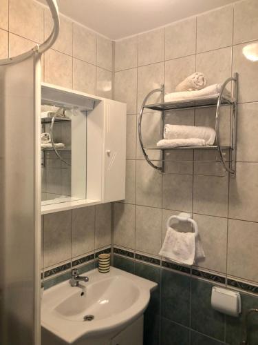 a bathroom with a sink and a mirror at Apartmani Leona in Bibinje