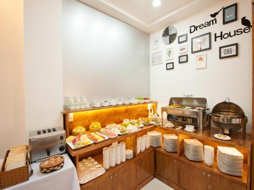 a restaurant kitchen with a buffet of food at Vilion Boutique Hotel Ben Thanh in Ho Chi Minh City