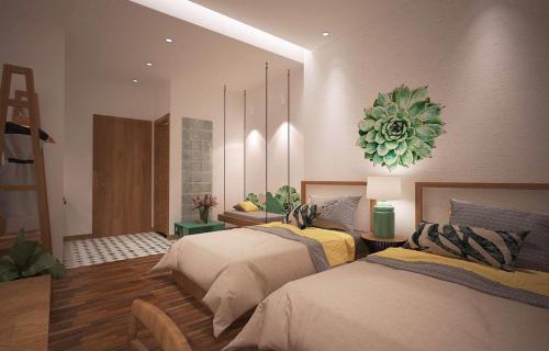 a bedroom with two beds and a chandelier at Banana Flower Homestay in Da Nang