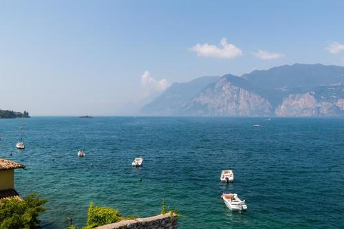 a group of boats in a large body of water at Hotel Vega in Malcesine