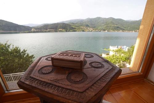 a table with a camera sitting on top of a window at Keep calm Lake edition in Konjic