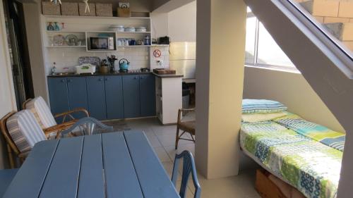 a room with a kitchen and a table and a table and a kitchen at Waterkant 4B in Jeffreys Bay