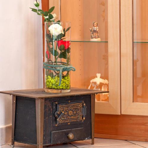 a vase with flowers on top of a table at Biogasthaus Wanker in Techelsberg am Worthersee