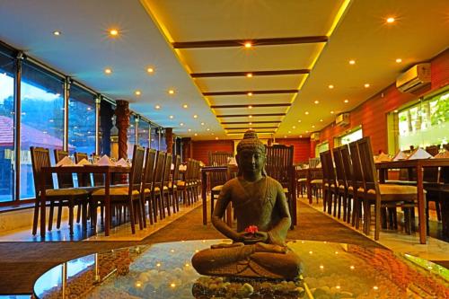 a statue in the middle of a room in a restaurant at Jal Mahal Resort and Spa in Mysore