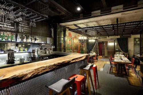 a restaurant with a bar and some tables and chairs at Hotel The Public - Special Category in Istanbul