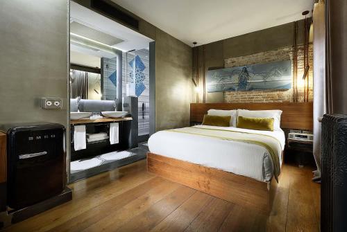 a bedroom with a large bed and a bathroom at Hotel The Public - Special Category in Istanbul