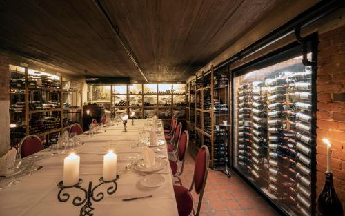 a long dining room with a long table with candles at Hotel Refsnes Gods - by Classic Norway Hotels in Moss