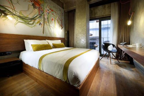 a bedroom with a large bed with a desk and a desk at Hotel The Public - Special Category in Istanbul