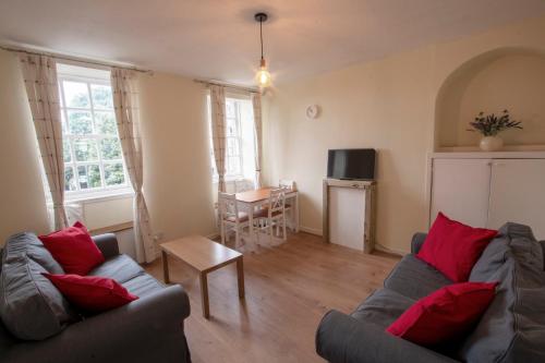 a living room with a couch and a table at Cadell House Apt - Royal Mile in Edinburgh