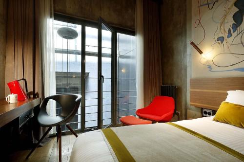 a hotel room with a bed and a chair at Hotel The Public - Special Category in Istanbul