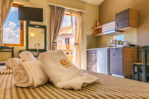 a hotel room with a bed with towels on it at Eko Suites in Georgioupolis