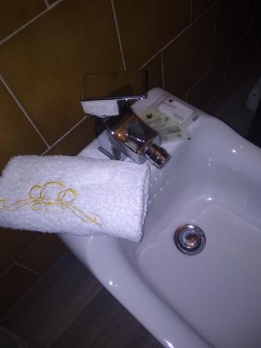 a white towel on a sink in a bathroom at Hotel Malta in Milan