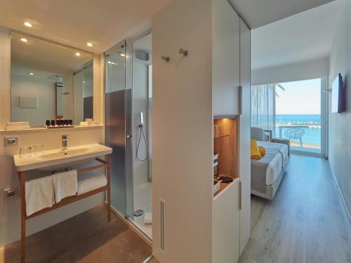 a bathroom with a sink and a shower with a view at BQ Aguamarina Boutique Hotel in Can Pastilla