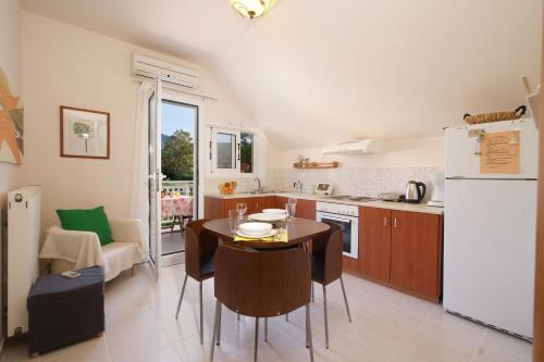a kitchen with a table and a refrigerator at Christina's place in Sami