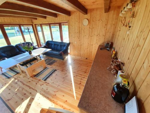 an overhead view of a living room with a couch and a table at UpeNes in Lubāna