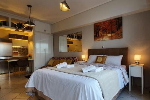 a bedroom with a large bed with two pillows on it at Cozy Luxury Apartment in the Heart of Athens 8-1 in Athens