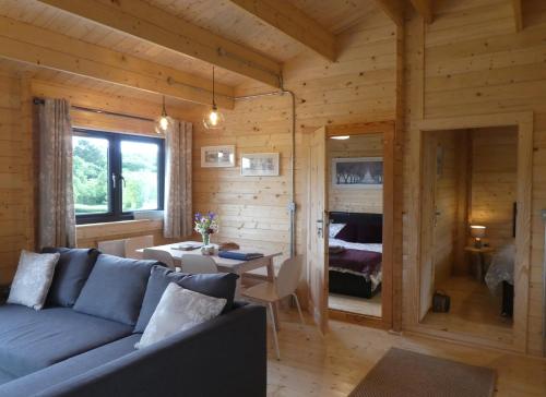 a living room with a couch and a bedroom at Pound Farm Holidays - Orchard Lodge in Cullompton