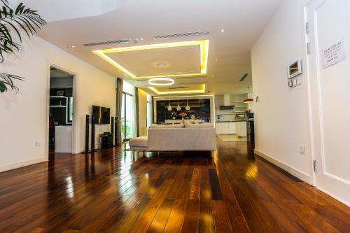 a living room with a couch on a hard wood floor at HNC Premier Hotel & Residences in Hanoi