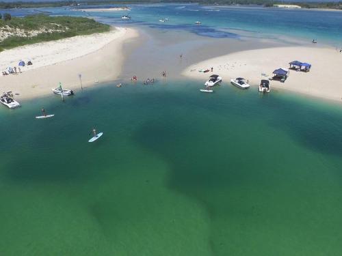 an aerial view of a beach with boats in the water at Champagne Court 1 in Tuncurry