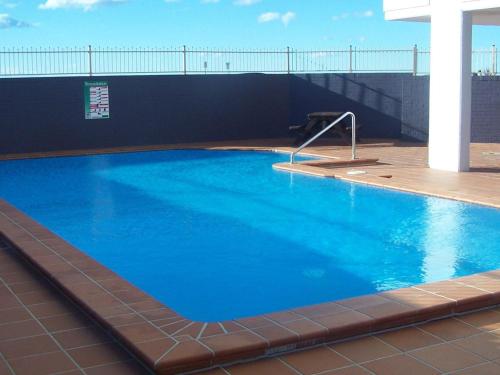 a large blue swimming pool on top of a building at Ebbtide 26 in Forster