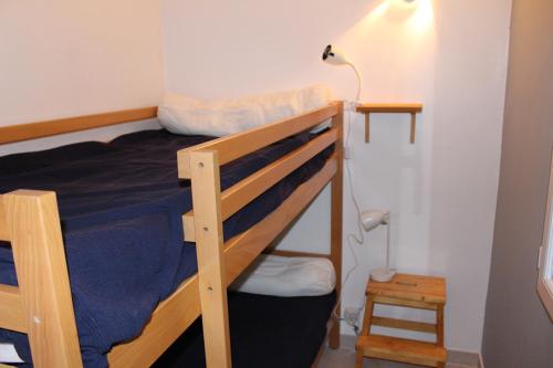a bedroom with two bunk beds and a lamp at le petit bois in Valaurie