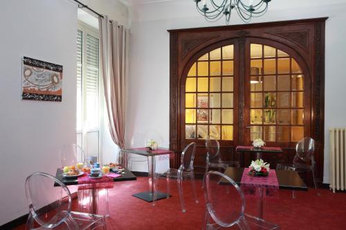 a dining room with chairs and tables and a large window at Alerion Centre Gare in Metz