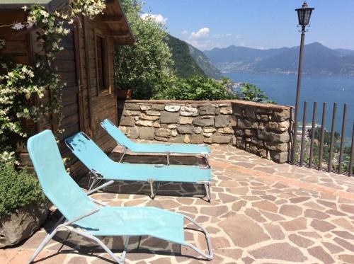2 sillas azules y una mesa en el patio en B&B La Forcella, en Sarnico