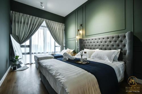 a bedroom with two beds and a large window at Anggun Residence Kuala Lumpur KLCC @ Icon Stay in Kuala Lumpur