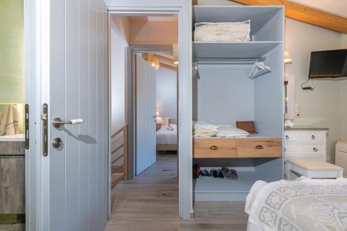 a small bedroom with a bed and a desk at Amelia & Nicholas Stone Houses in Doukádes